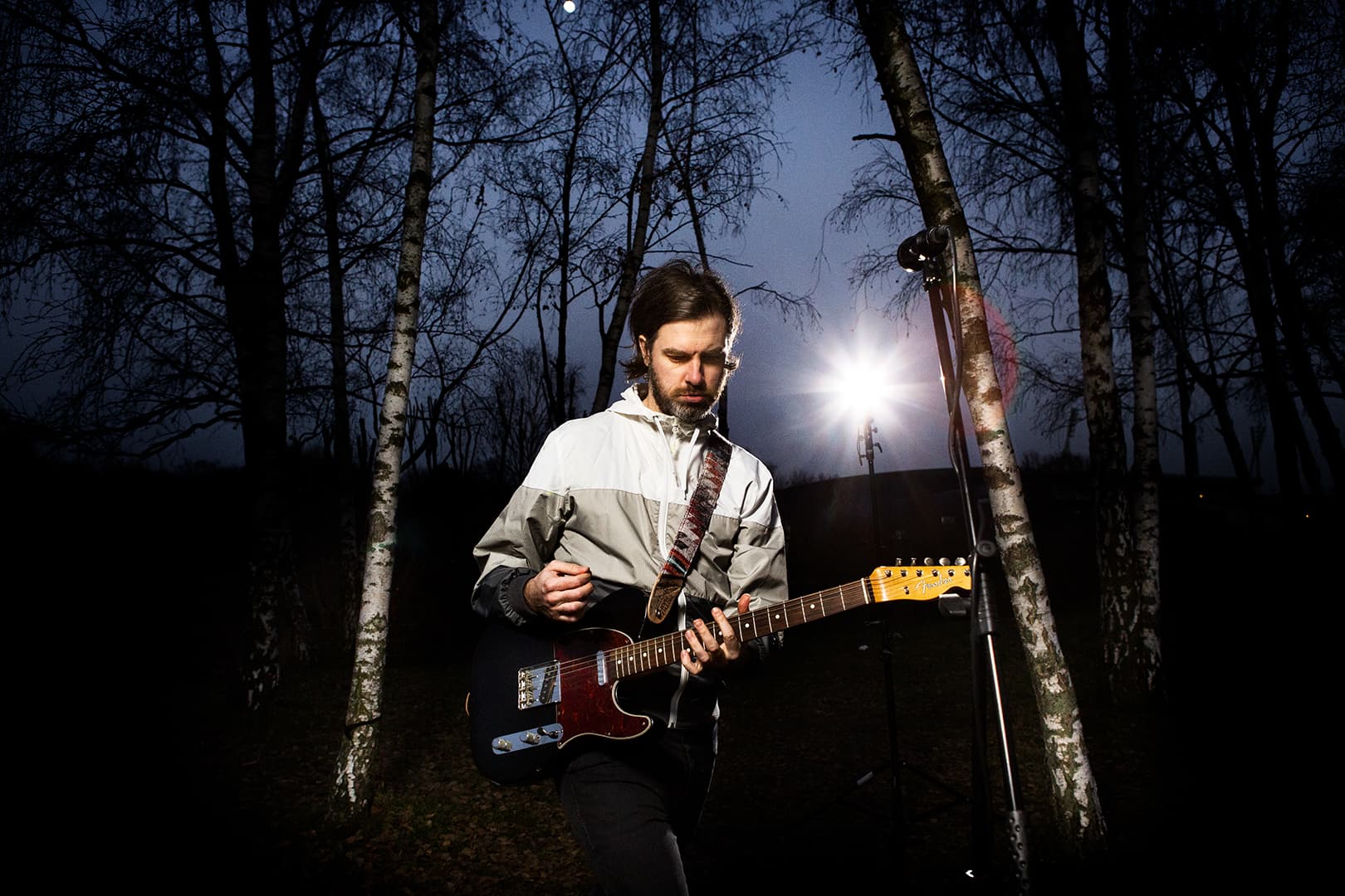 Action Shot of musician Gregor McEwan performing on a guitar